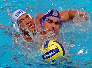 Italian Allessandro Calcaterra (R) fights or the ball with Dimitros Mazis of Greece during their Water Polo World Cup match in Budapest June 15, 2006.