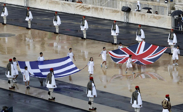 The flame for the London Olympics, which will start on July 27 after a 70-day torch relay around Britain, was handed over on Thursday at a damp ceremony in the marble stadium that hosted the first modern Games in 1896. London receives flame in rainy Athens