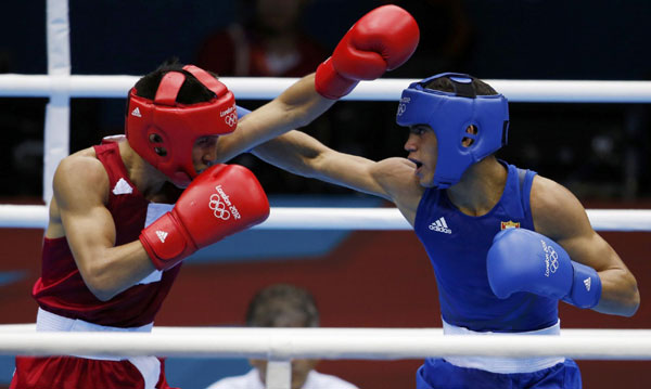 Mongolia's Tugstsogt Nyambayar (L) fights Cuba's Robeisy Ramirez Carrazana during their Men's Fly (52kg) gold medal boxing match at the London Olympics August 12, 2012. Cuban boxer wins boxing men's 52kg gold medal