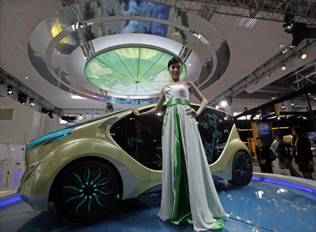 Model poses next to IAT 'Zu' electric concept car