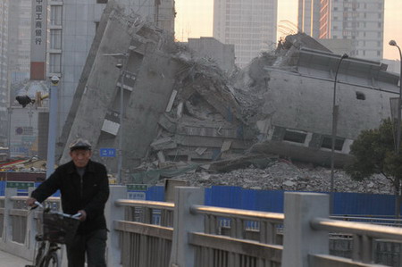 Buildings fall with blast demolition