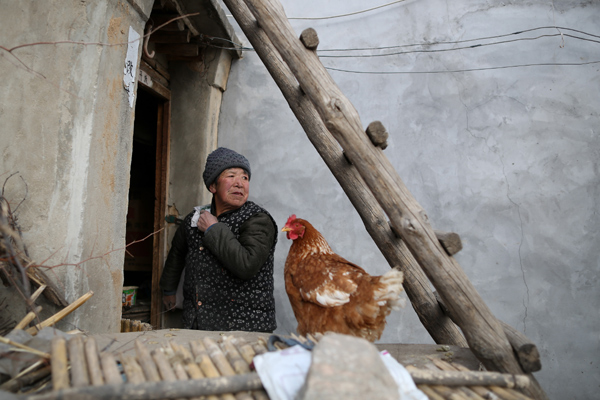 A villager at the entrance of his house in Luotuowan village, Fuping County, Dec 31, 2013. Poor village gets $48 million after Xi's visit