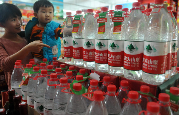 A bottled water display in a supermarket in Qionghai, Hainan province, catches a child's interest on Saturday. Meng Zhongde / for China Daily Quality concerns over bottled water