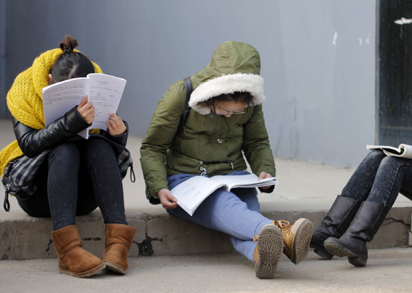 Candidates for the entrance examination for postgraduate studies prepare before they enter an exam venue in Rizhao, Shandong province, on Sunday. No room at the inn for some test-takers