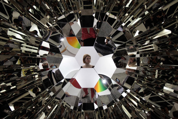 A woman walks past the art work 'Your Plural View' by Olafar Eliasson of Denmark at the Hong Kong International Art Fair May 25, 2011. HK welcomes world's leading galleries