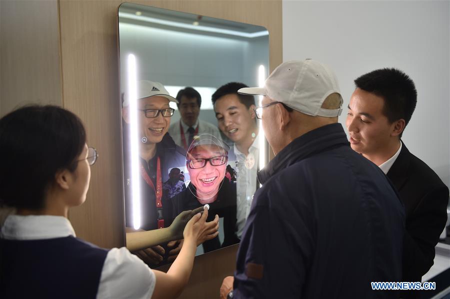 Hugging, calligraphy writing robots featured in Yuyao