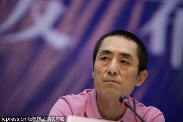 Chinese director Zhang Yimou listens during a press conference in Beijing, 19 July 2013. Zhang's case to follow the law