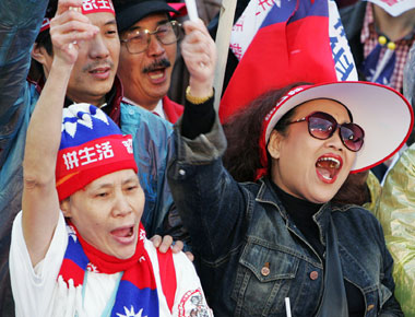 Supporters of Taiwan's main opposition Nationalist Party shout slogans during a protest march in Taipei March 12, 2006. Thousands of people marched through Taiwan's capital on Sunday to denounce President Chen Shui-bian, accusing him of fanning tensions with neighbouring China.