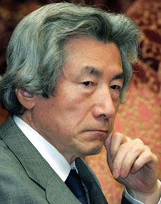 Japan's Prime Minister Junichiro Koizumi listens to a question from an opposition at an Upper House budget committee session of parliament in Tokyo March 17, 2006.