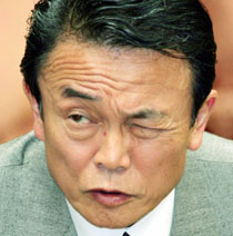 Japan's Minister for Foreign Affairs Taro Aso squints during a question-and-answer session at the Upper House budget committee in parliament in Tokyo March 17, 2006.