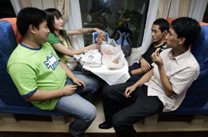 Passengers chat on board the first Beijing-to-Lhasa train moments before it leaves the Beijing railway station July 1, 2006.