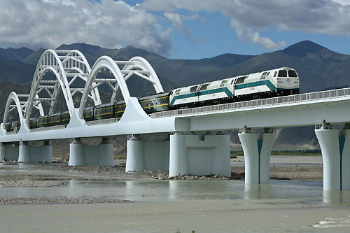 The first train from Lhasa Railway Station in Lhasa, Tibet, travels along a bridge heading for Lanzhou in Gansu province July 1, 2006.