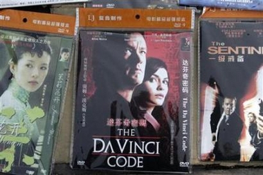 A pirated DVD version of 'The Da Vinci Code' movie is displayed for sale along a sidewalk in Beijing in this May 22, 2006 file photo. China sentenced a man to life in jail on Thursday for running what state media called the country's biggest ever pirate film disc smuggling ring.