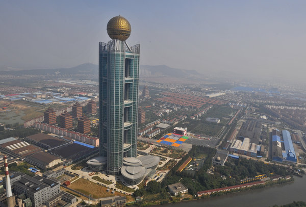The newly built 328-meter-high 74-storey hotel towers over Huaxi village, East China’s Jiangsu province, Oct 8, 2011. Lavish hotel opens in China's richest village
