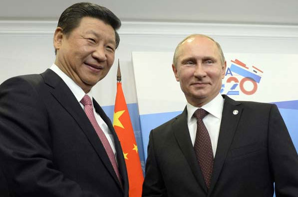 President Xi Jinping and his Russian counterpart Vladimir Putin have a talk before they attend a meeting of G20 leaders in St Petersburg, Russia, on Thursday. China's growth positive for world economy