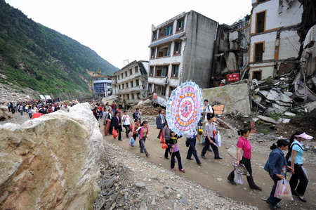 China opens quake-leveled county to mourners