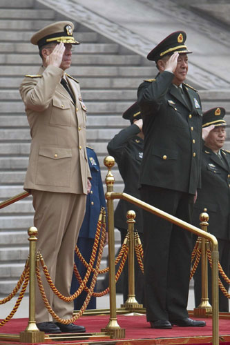 General Chen Bingde, chief of the General Staff of the Chinese People's Liberation Army, and US Admiral Mike Mullen (L), chairman of the Joint Chiefs of Staff, salute during a welcoming ceremony for Mullen at the Bayi Building in Beijing July 11, 2011. China, US announce military exchange plans
