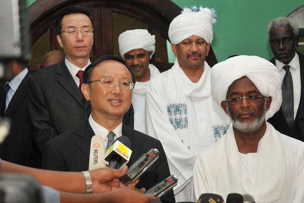 Foreign Minister Yang Jiechi speaks to the media as his Sudanese counterpart Ali Karti (right) listens in Khartoum on Monday. FM visits fledgling nation South Sudan