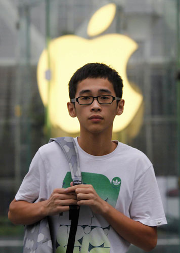 A teenager walks out of an Apple retail store at the financial district in Shanghai August 25, 2011. Apple's CEO resignation makes ripples in China
