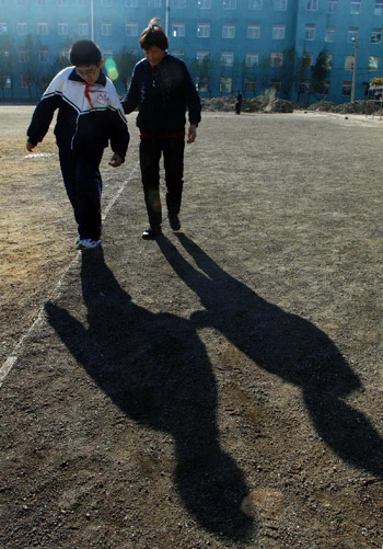Mother and son share a desk at school Mother and son share a desk at school