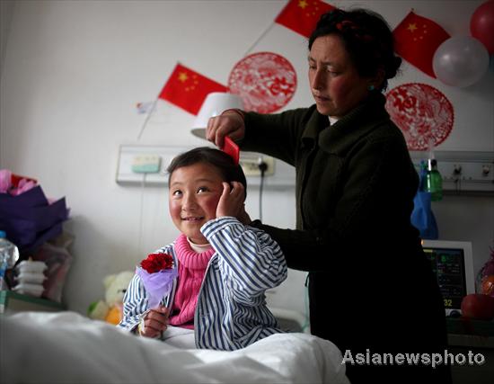Pedmayangchen’s mother combs her hair in the hospital, Jan 30, 2012. Tibetan children get free heart treatment