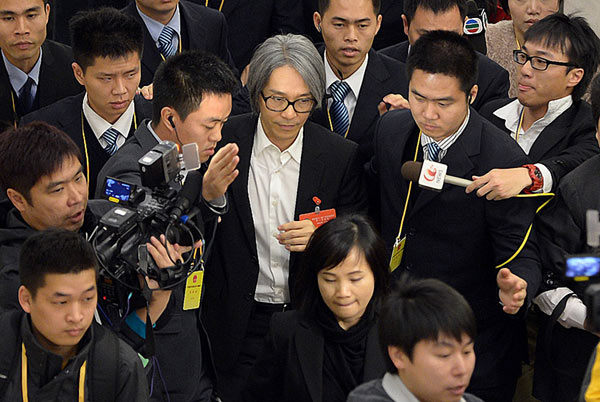 Stephen Chow, the Hong Kong comedian, film director and a political adviser to Guangdong province, is surrounded by reporters in the provincial capital, Guangzhou, on Friday. Stephen Chow's role as political adviser sees rocky start