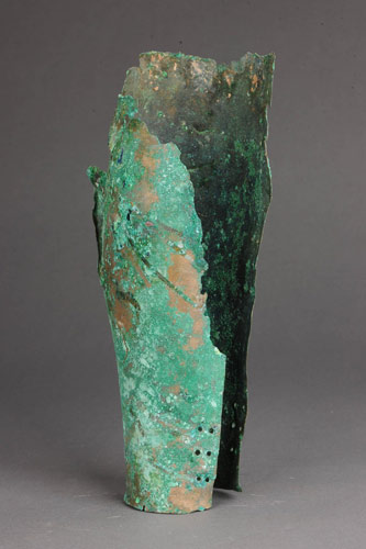 A piece of thigh armor is found from a tomb of the West Zhou Dynasty (1046-771 BC), in Baoji city, Shaanxi province, March 10, 2013. Archaeologists find earliest bronze armor pieces