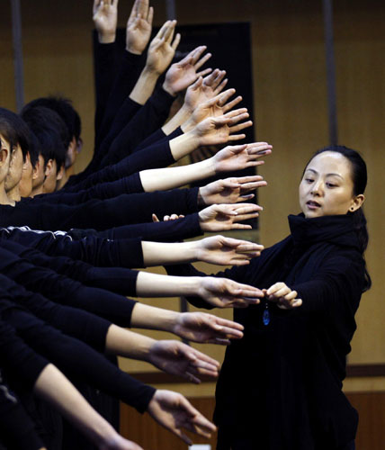 Tai Lihua directs China Disabled People's Performing Art Troupe in The Thousand-Handed Goddess of Mercy dance. The signs are good
