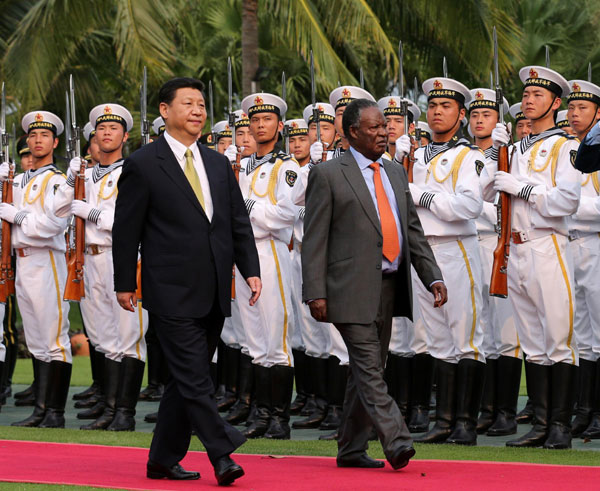 President Xi Jinping, left front, holds a welcoming ceremony for visiting Zambian President Michael Chilufya Sata ahead of their talks in Sanya, South China's Hainan province, April 6, 2013. China-Zambia relations a model of win-win approach