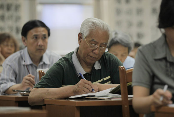 Students take notes in a calligraphy class. Never too old to learn new tricks