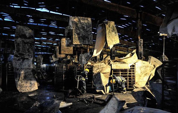 Firefighters search for survivors at the burnt poultry slaughterhouse owned by the Jilin Baoyuanfeng Poultry Company, June 3, 2013. Poultry plant fire death toll rises to 120