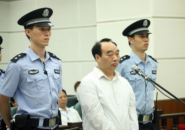 Lei Zhengfu, a former official of Chongqing's Beibei district, stands trial on June 19 in a court in the city. Chongqing ex-official gets 13 yrs
