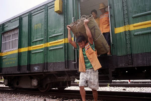 A worker unloads goods from a Vietnamese train at Shanyao station. Photo by Feng Yongbin / China Daily Tunnel builders sweat it out on new rail line