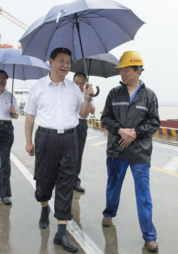 President Xi Jinping (L, front), who is also general secretary of the Communist Party of China (CPC) Central Committee, inspects the Yangluo container port in Wuhan, the capital of central China's Hubei Province, July 21, 2013. Xi urges deepening reform, opening up