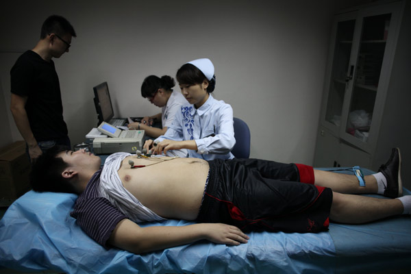 A student undergoes a medical check at a Beijing hospital during China's first summer and autumn recruitment program. Wang Jing / China Daily Get ready for roll call