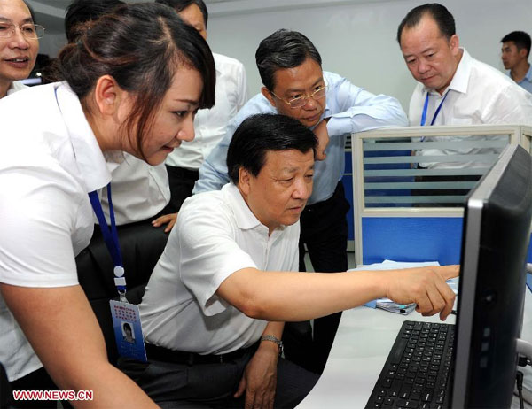 Liu Yunshan (C), a member of the Standing Committee of the Political Bureau of the Communist Party of China (CPC) Central Committee, visits the provincial mass work center in Guiyang, the capital of Southwest China's Guizhou province, Aug 23, 2013. Senior leader stresses improving CPC work style