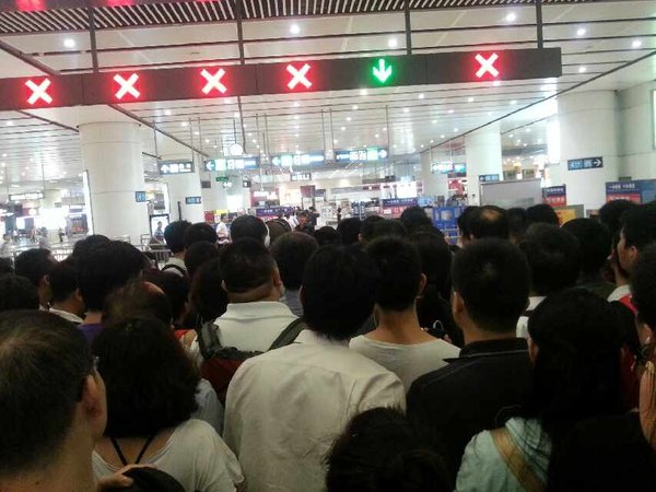 Passengers are stranded outside the entrance of a Beijing's No 4 subway line station which suspends operation due to signal failure on Monday morning. Beijing's No 4 subway line suspended due to signal failure