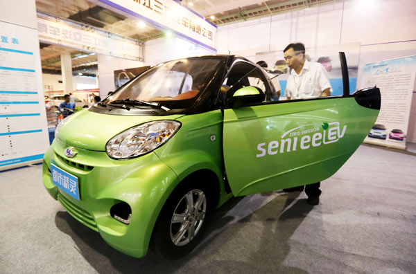 A man checks out an electric mobile at a new energy auto show in Beijing in July. The capital plans to tackle air pollution by promoting the use of green vehicles and cutting annual gasoline and diesel fuel consumption. Road to clean air starts with new energy vehicles
