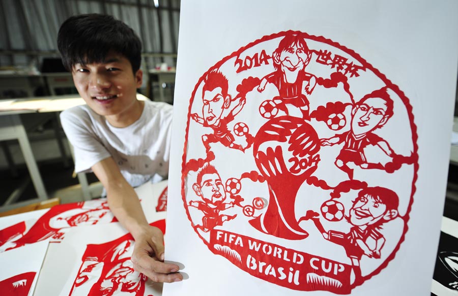 Young craftsman scissors World Cup on paper