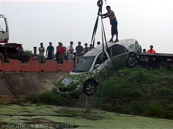 Calm driver waits on top of sinking car for help