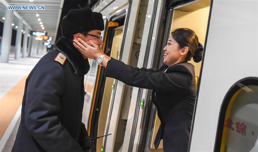 Young couple as railway workers busy for Spring Festival travel rush
