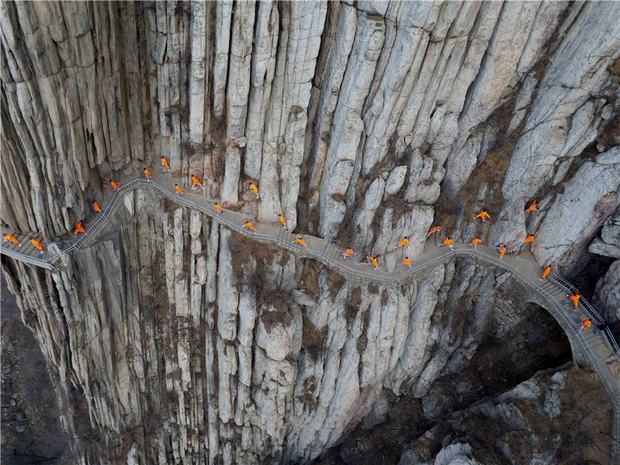 Martial artists practice Shaolin kung fu on cliff