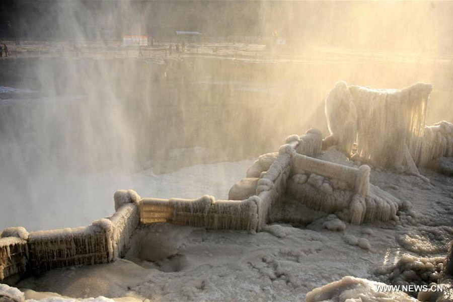 Visitors view frozen Hukou Waterfall on Yellow River