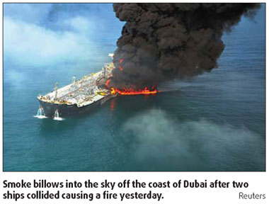 Oil tanker, container set ablaze after collision