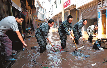 13 missing after landslide blankets village