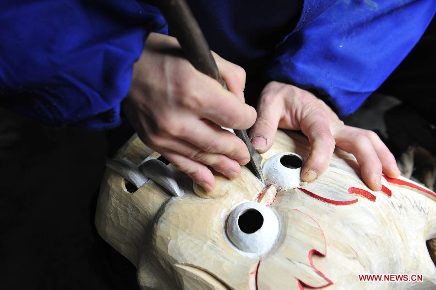 Folk artisan works on Nuo Opera masks