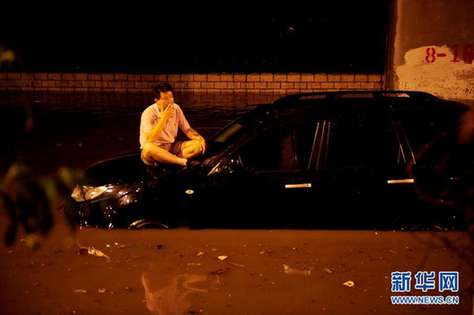 北京夜降暴雨 積水中勇現(xiàn)“淡定哥”(組圖)