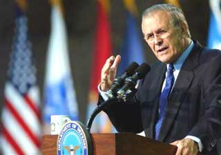 U.S. Secretary of Defense Donald Rumsfeld gives a speech to American troops at Camp Udairi, north of Kuwait City on Wednesday, Dec. 8, 2004. (AP 