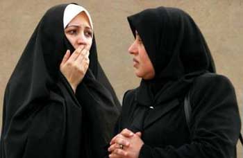 Iraqi women react as they view the scene of a car bomb attack in Baghdad January 18, 2005. The suicide car bomb exploded on Tuesday at a Baghdad office of the Supreme Council for the Islamic Revolution in Iraq (SCIRI), a party official said, in the latest attack on Shi'ites before Iraq's January 30 election. The official said there was no immediate word on casualties. [Reuters]