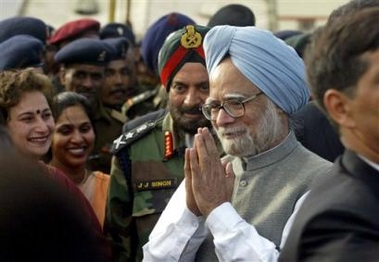 Indian Prime Minister Manmohan Singh, center, interacts with Indian army soldiers as Indian army chief J.J.Singh, in green and red turban, looks on in Leh, India, Saturday, June 11, 2005.
